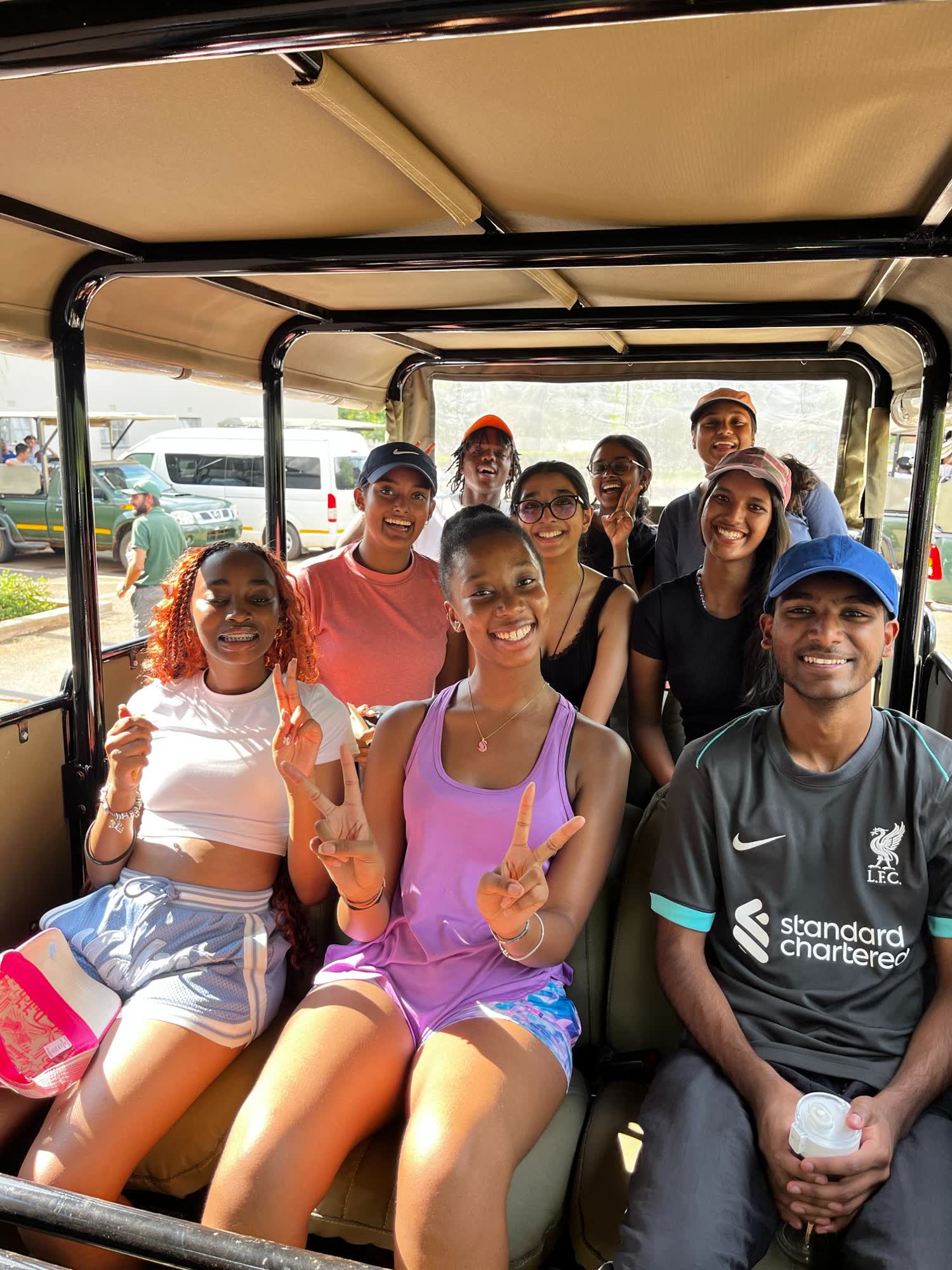Campers on an open game drive vehicle in the Pilanesberg bushveld near Camp Wildside