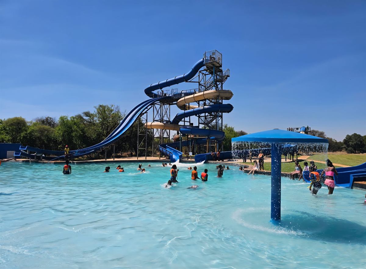 The Camp Wildside waterpark: slide tower, splash pool and mushroom fountain under a blue sky