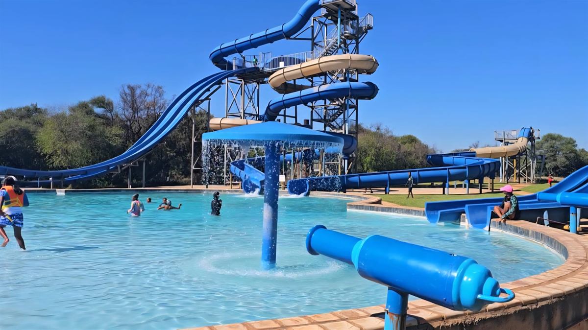 The waterpark pool with the water cannon in front and the slide tower behind